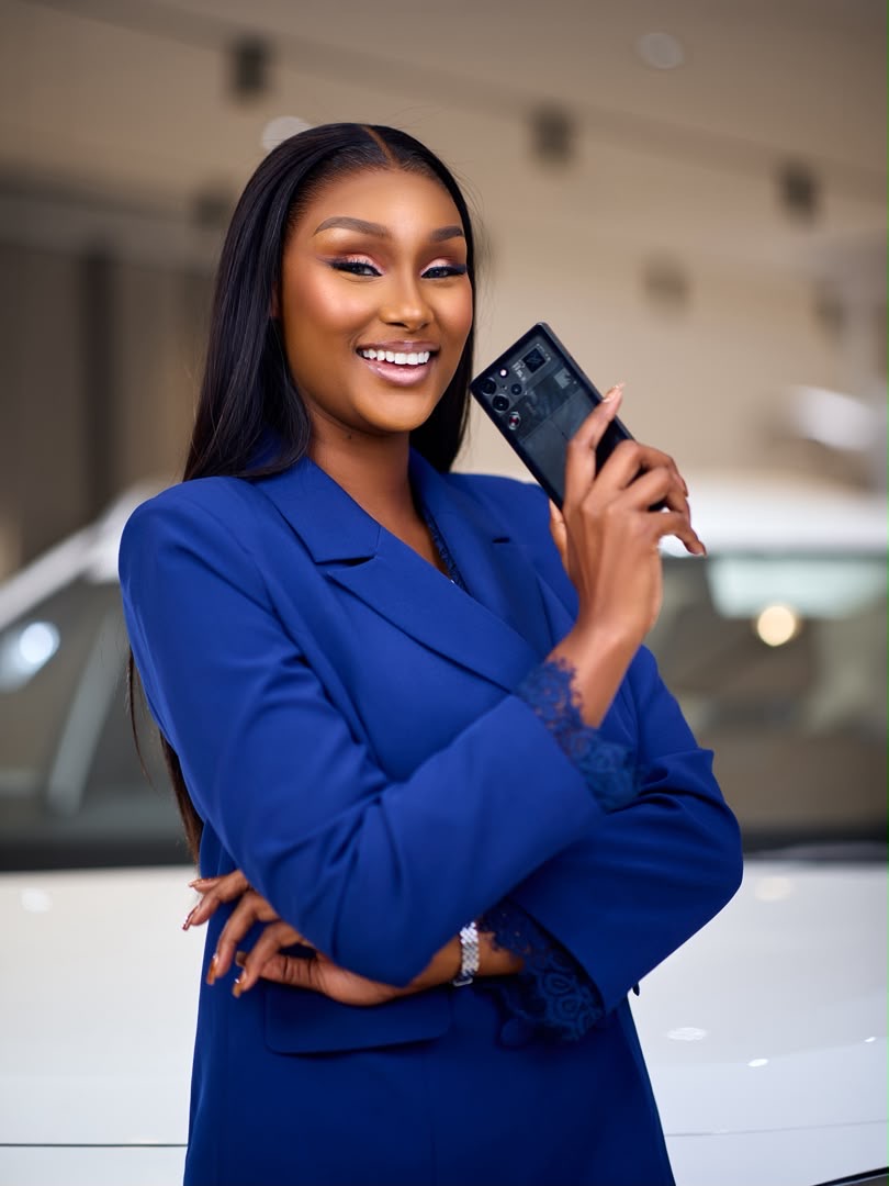 Brand ambassador holding a smart device in a vehicle showroom