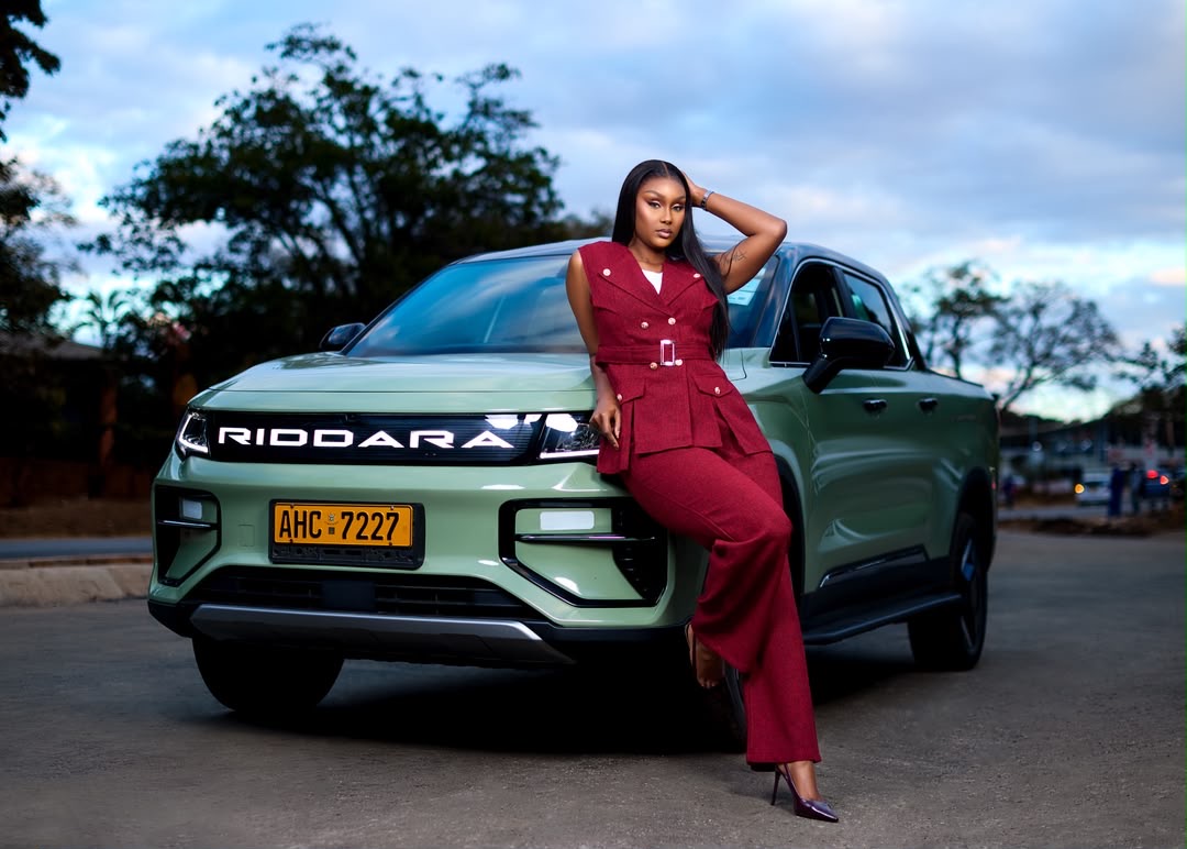 Green Riddara electric pickup with brand ambassador